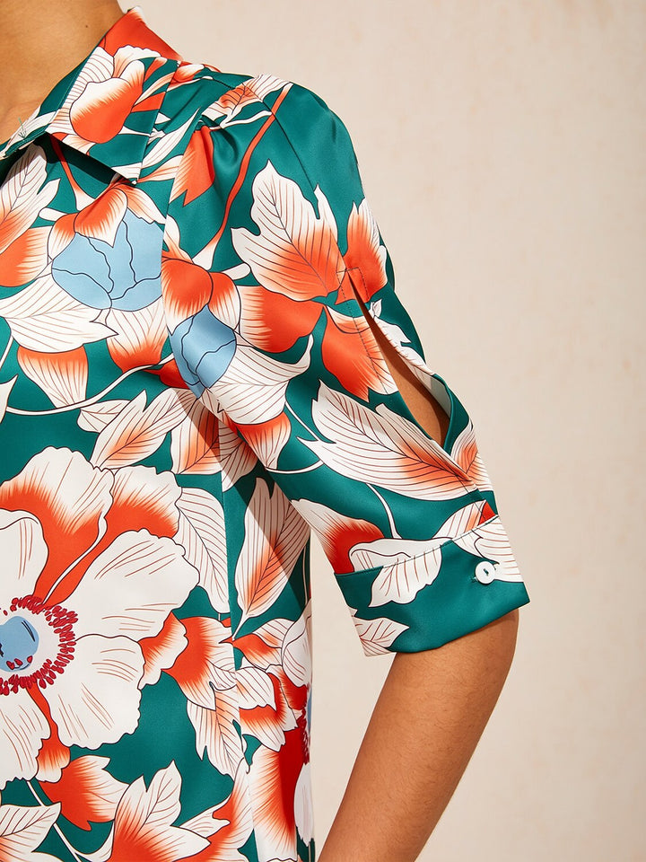 Silky satin shirt dress for women featuring a vibrant floral design in deep green hibiscus, offering a relaxed fit and tropical style perfect for summer outings. 2