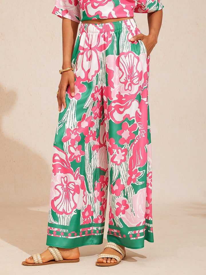 Silky satin wide leg pants featuring an elastic waist and vibrant tropical print, designed for a flowy relaxed fit for women. 10