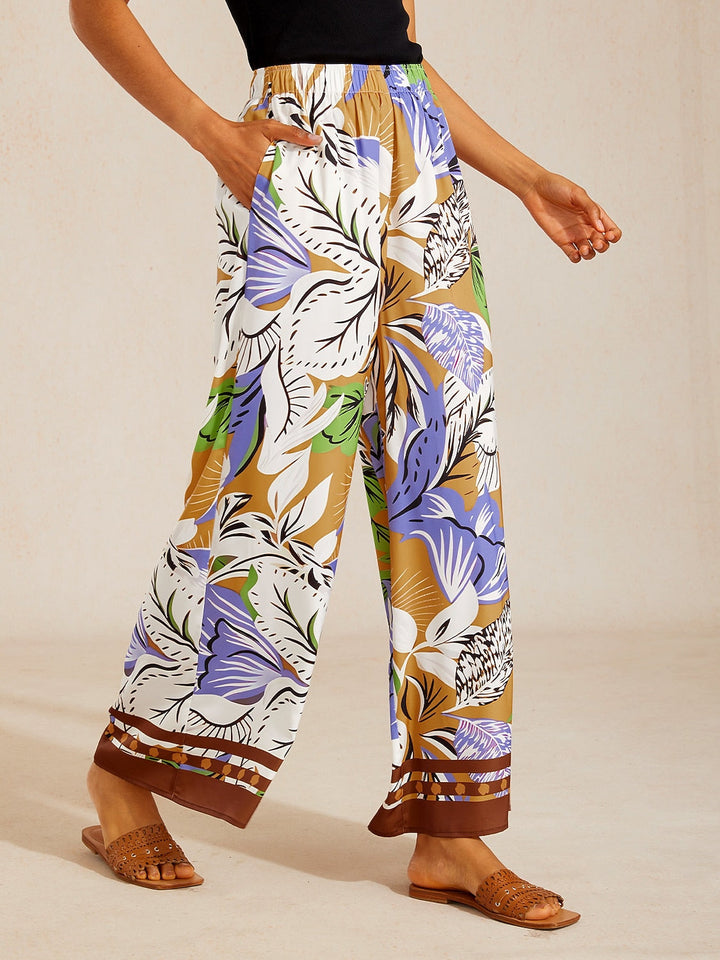 Silky satin wide leg pants featuring an elastic waist and vibrant tropical print, designed for a flowy relaxed fit for women. 12