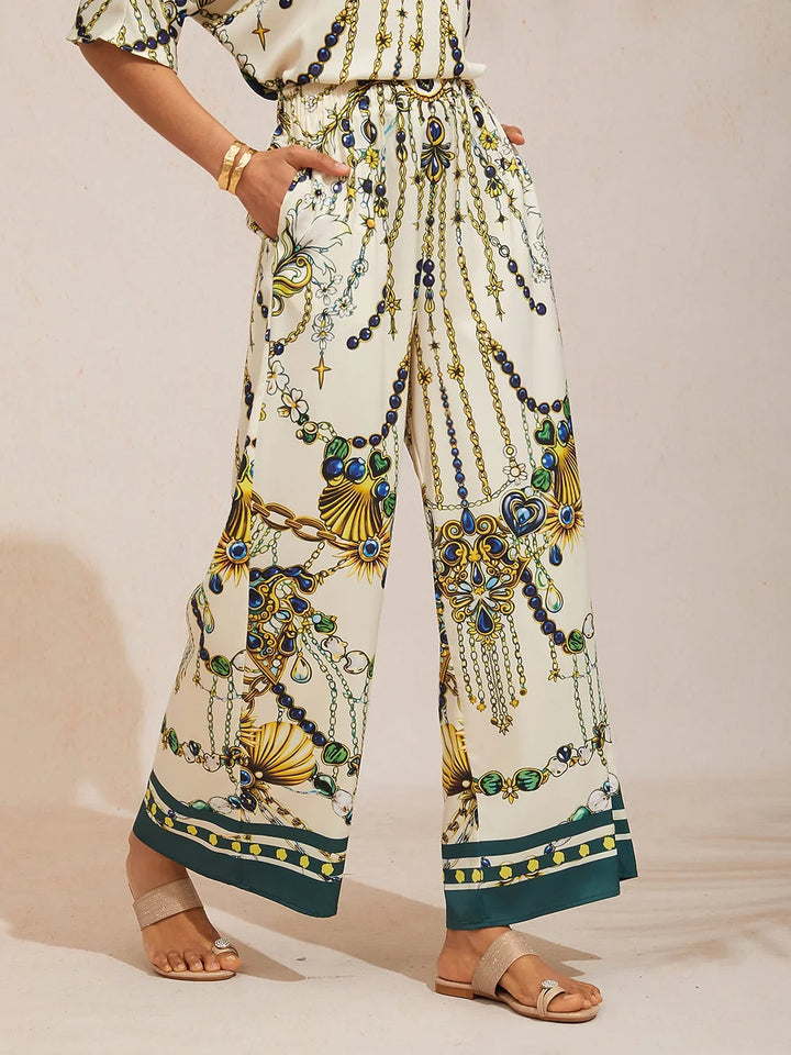 Silky satin wide leg pants featuring an elastic waist and vibrant tropical print, designed for a flowy relaxed fit for women. 15