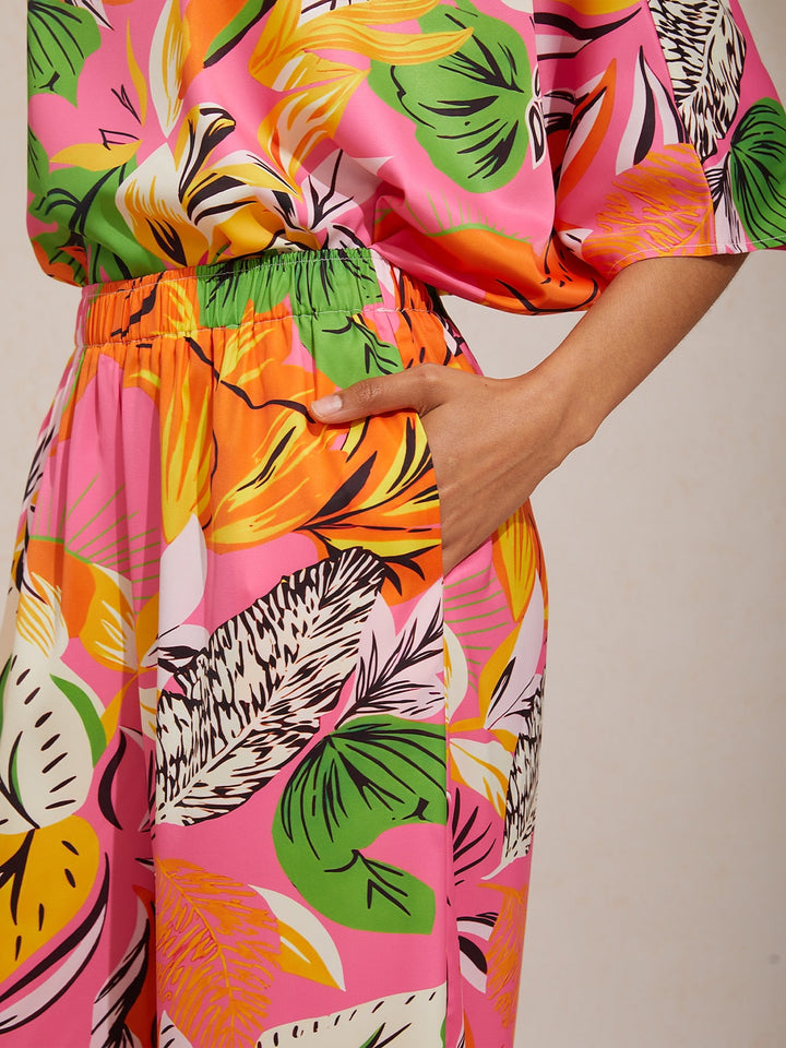 Silky satin wide leg pants featuring an elastic waist and vibrant tropical print, designed for a flowy relaxed fit for women. 3