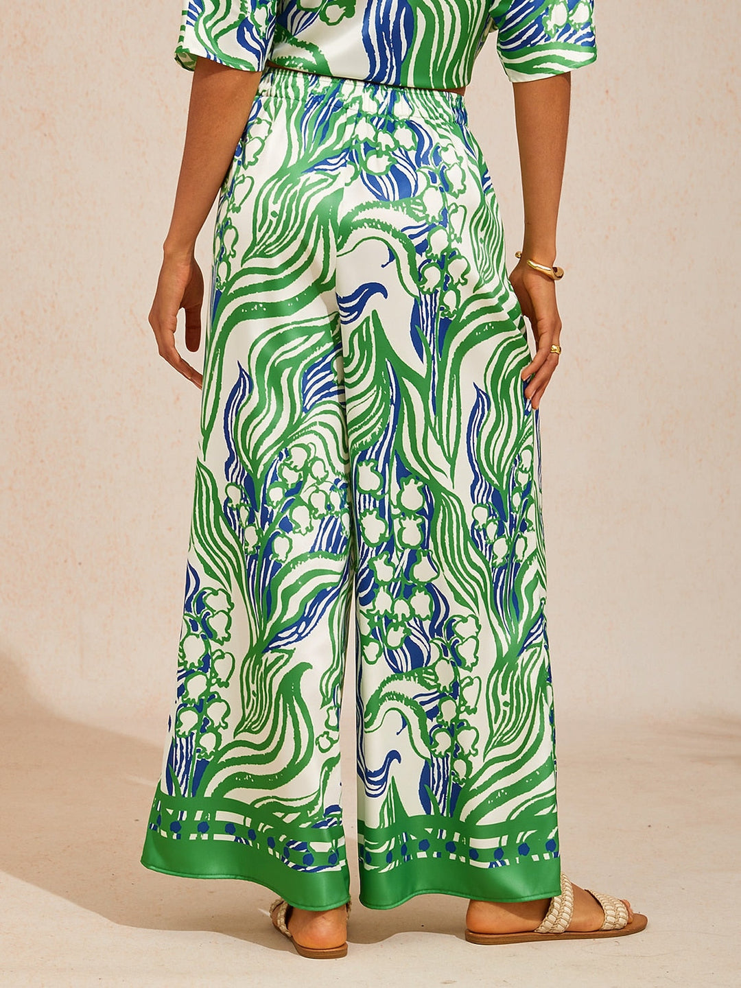 Silky satin wide leg pants featuring an elastic waist and vibrant tropical print, designed for a flowy relaxed fit for women. 6