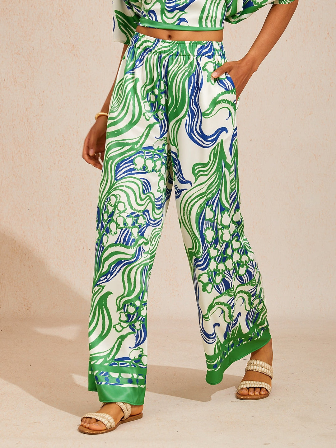 Silky satin wide leg pants featuring an elastic waist and vibrant tropical print, designed for a flowy relaxed fit for women. 7