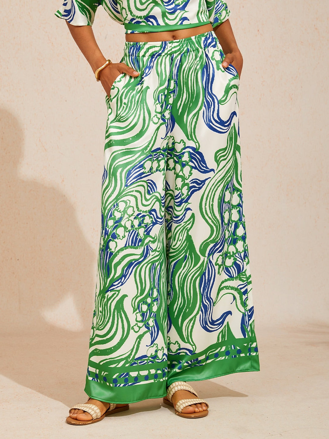 Silky satin wide leg pants featuring an elastic waist and vibrant tropical print, designed for a flowy relaxed fit for women. 8
