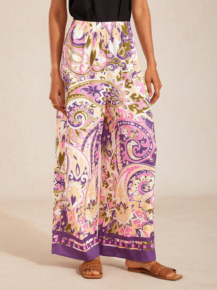 Silky satin wide leg pants featuring an elastic waist and vibrant tropical print, designed for a flowy relaxed fit for women. 9