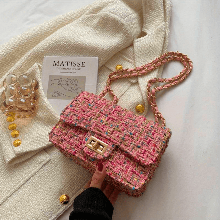 Structured shoulder bag featuring a stylish bouclé exterior and a chic chain strap, designed for women seeking elegance in everyday accessories. 0