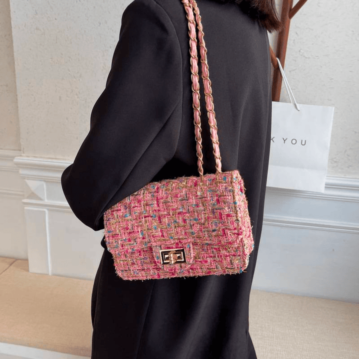 Structured shoulder bag featuring a stylish bouclé exterior and a chic chain strap, designed for women seeking elegance in everyday accessories. 2
