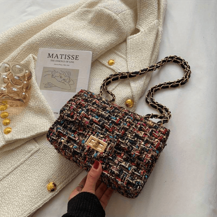 Structured shoulder bag featuring a stylish bouclé exterior and a chic chain strap, designed for women seeking elegance in everyday accessories. 3