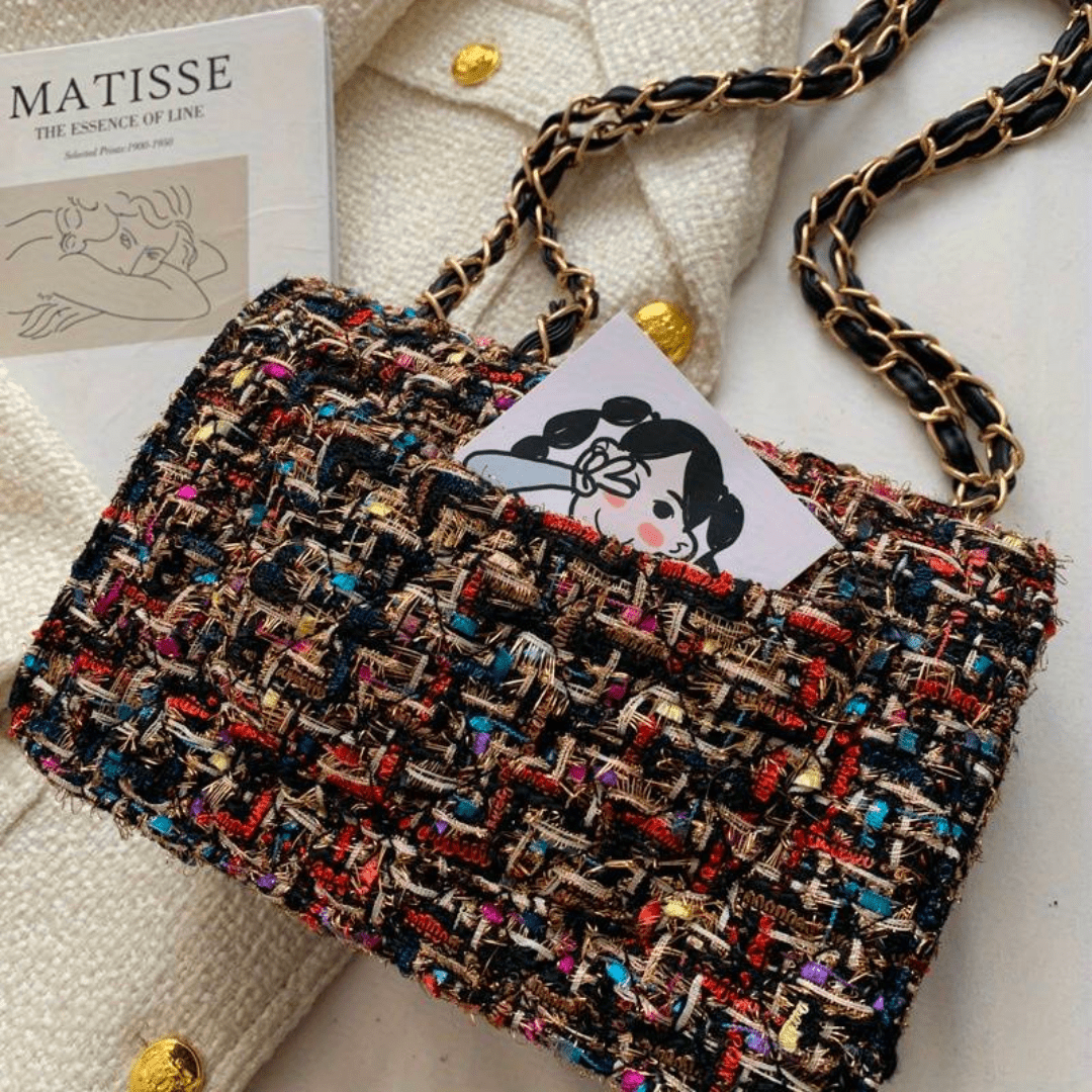 Structured shoulder bag featuring a stylish bouclé exterior and a chic chain strap, designed for women seeking elegance in everyday accessories. 4