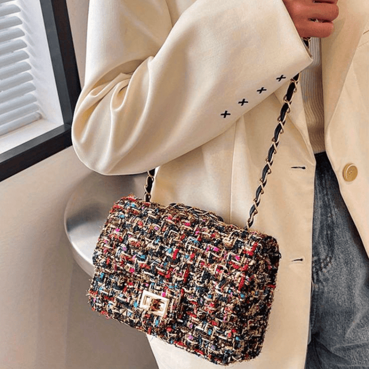 Structured shoulder bag featuring a stylish bouclé exterior and a chic chain strap, designed for women seeking elegance in everyday accessories. 5