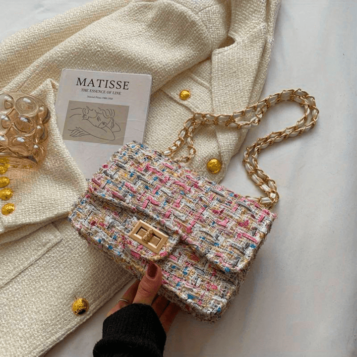 Structured shoulder bag featuring a stylish bouclé exterior and a chic chain strap, designed for women seeking elegance in everyday accessories. 6