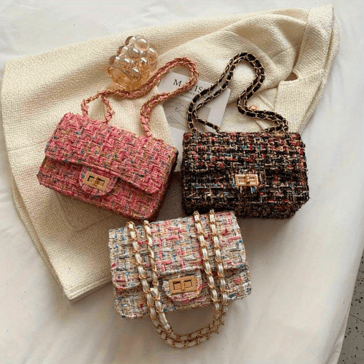 Structured shoulder bag featuring a stylish bouclé exterior and a chic chain strap, designed for women seeking elegance in everyday accessories. 7