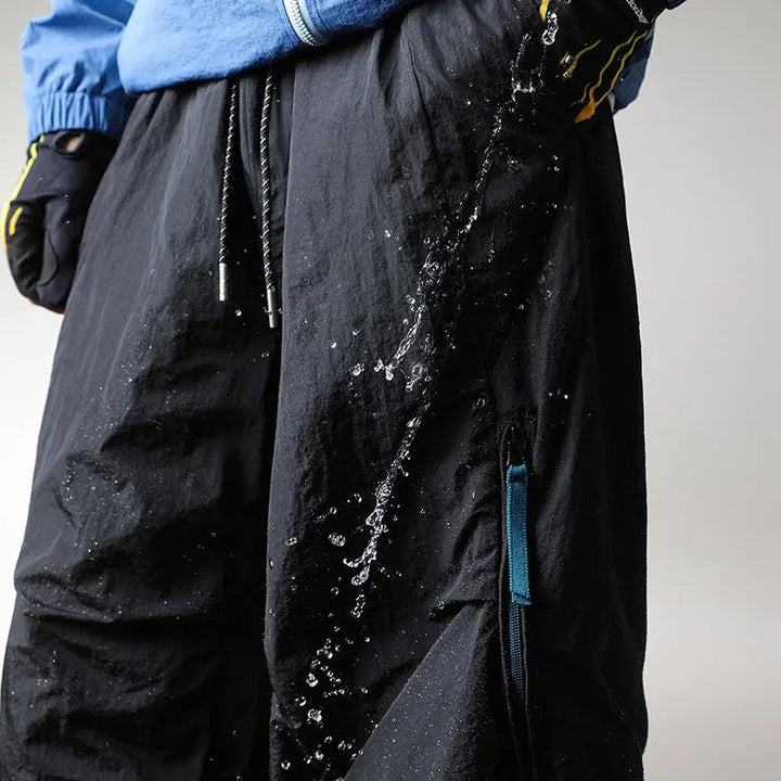 Waterproof hiking pants featuring quick-dry fabric and a comfort stretch waist, designed for durability and flexibility during outdoor trekking for both men and women. 2