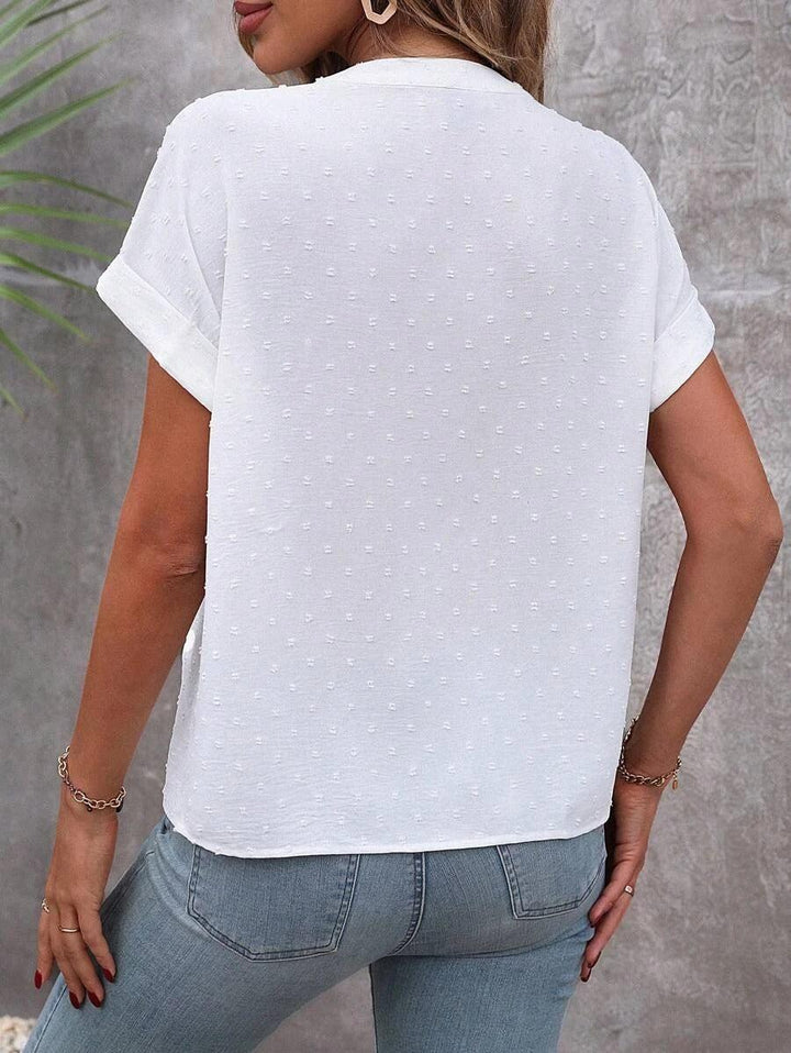 White Swiss Dot Blouse featuring stylish button detail, perfect lightweight summer top for women, ideal for casual or dressy occasions. 2
