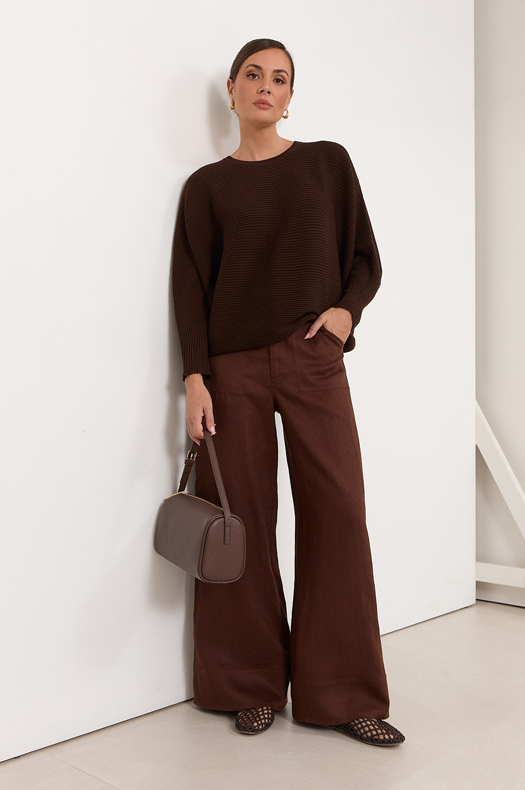 Wide leg linen pants for women in chocolate color, featuring a zip fly and pockets, perfect for casual style and comfortable wear. 0