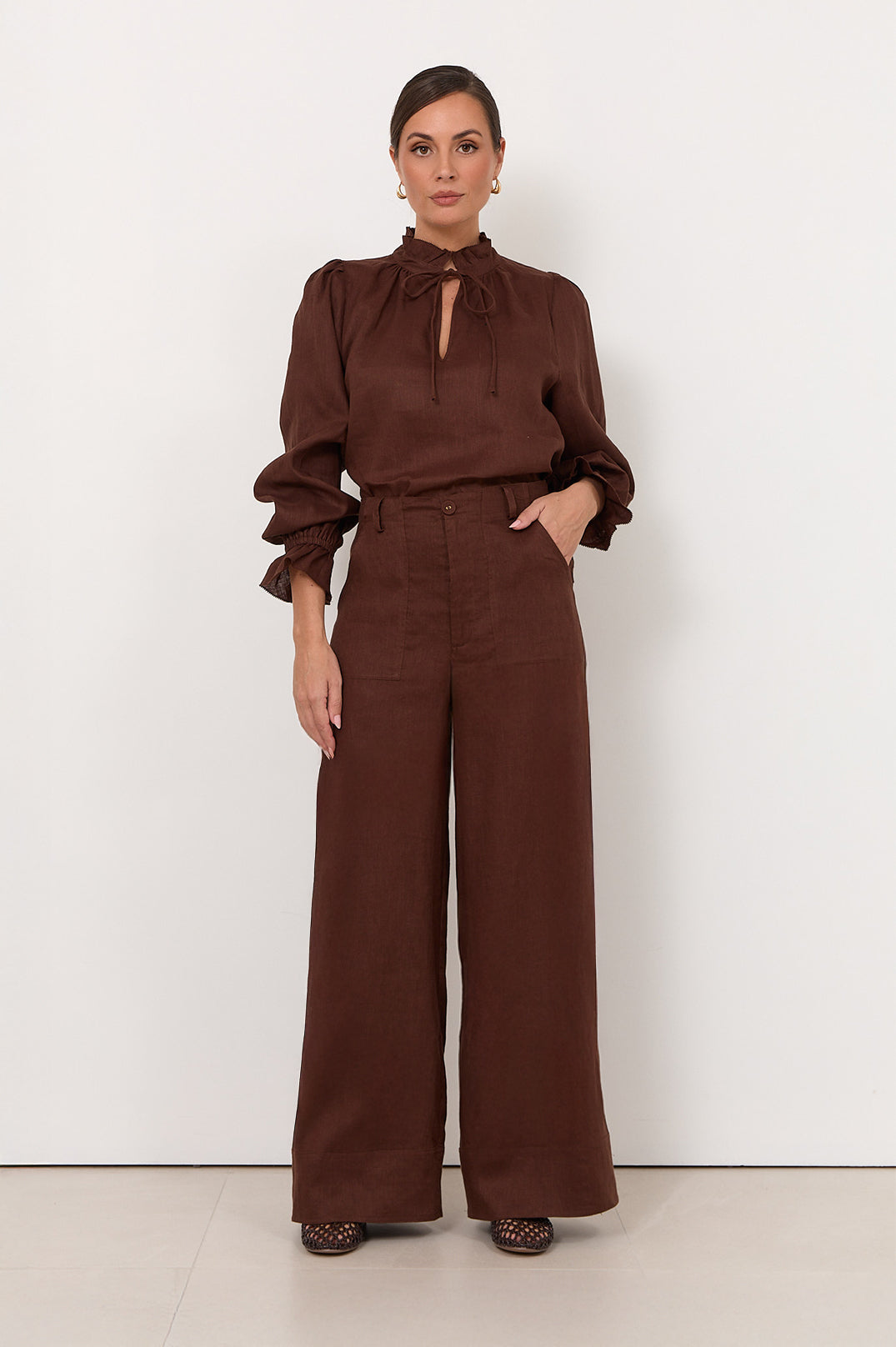 Wide leg linen pants for women in chocolate color, featuring a zip fly and pockets, perfect for casual style and comfortable wear. 1