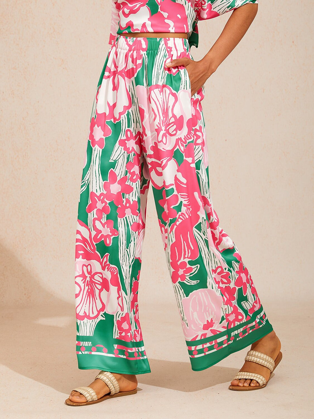 Wide leg pants for women made of silky satin featuring an elastic waist and a floral design in cream and yellow. 9