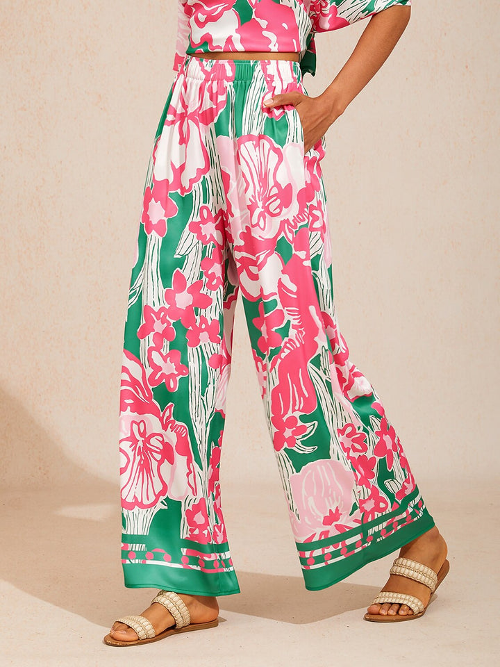 Wide leg pants for women made of silky satin featuring an elastic waist and a floral design in cream and yellow. 9
