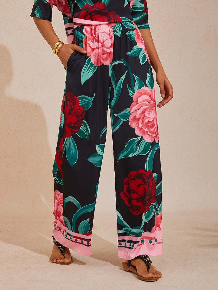 Wide leg pants for women in silky satin featuring an elastic waist and side pockets, adorned with a golden petal print for a flowy and stylish look 10