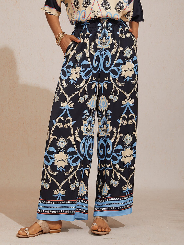 Wide leg pants for women in silky satin featuring an elastic waist and side pockets, adorned with a golden petal print for a flowy and stylish look 14
