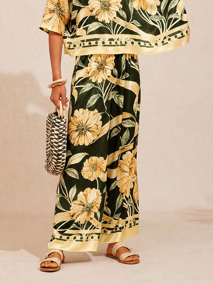 Wide leg pants for women in silky satin featuring an elastic waist and side pockets, adorned with a golden petal print for a flowy and stylish look 16