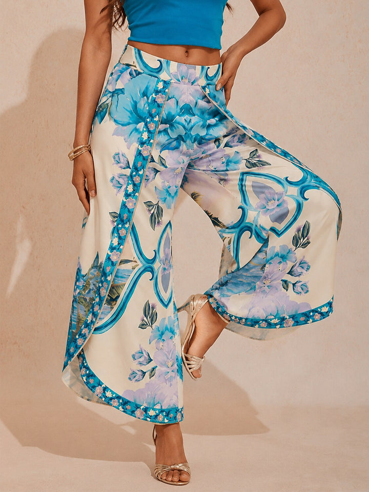 Wide leg pants for women featuring a vibrant tropical palm print, designed in a relaxed fit with luxurious satin fabric, presented in an eye-catching peacock blue 2