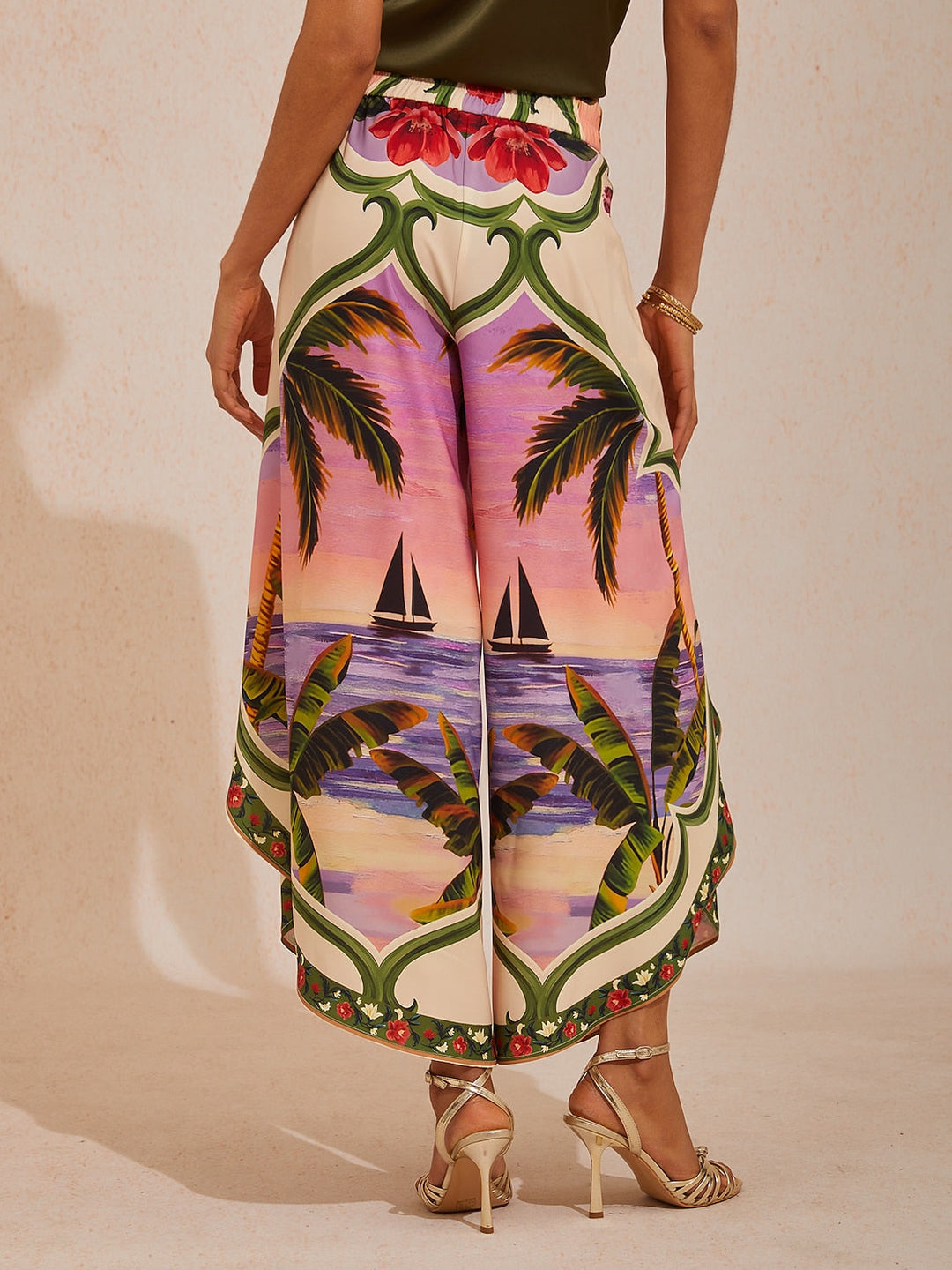 Wide leg pants for women featuring a vibrant tropical palm print, designed in a relaxed fit with luxurious satin fabric, presented in an eye-catching peacock blue 5