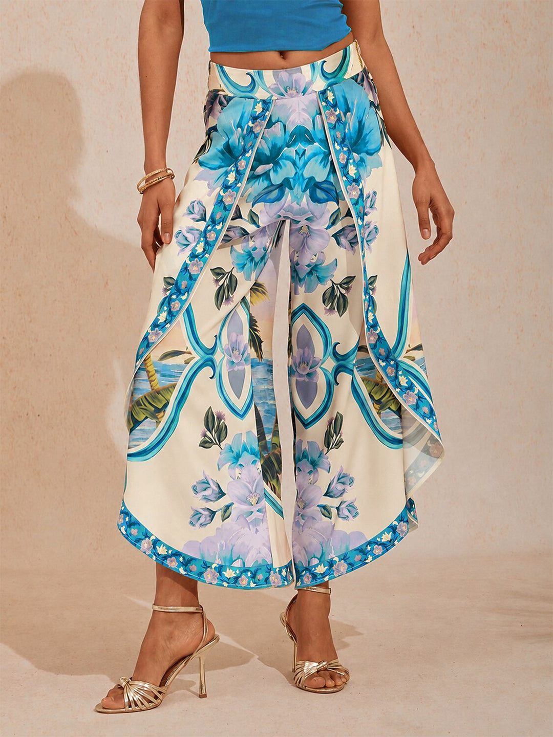 Wide leg pants featuring a high-rise waist in a silky satin fabric with a vibrant tropical floral print, perfect for stylish summer outings. 11