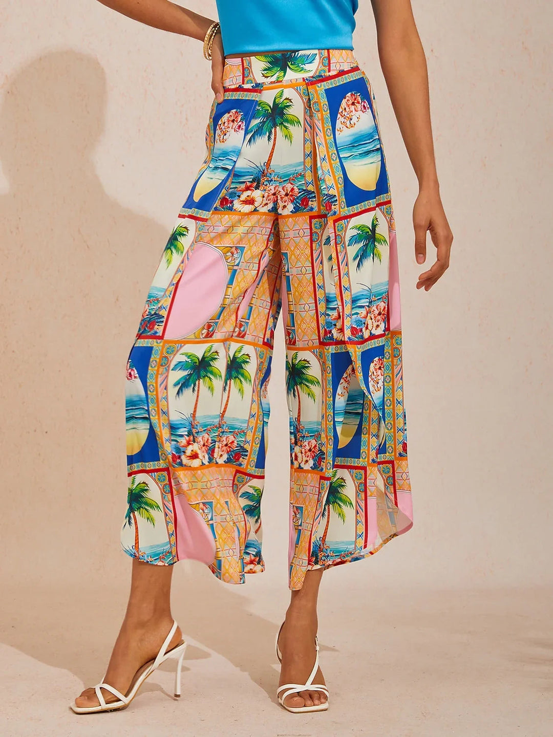 Wide leg pants featuring a high-rise waist in a silky satin fabric with a vibrant tropical floral print, perfect for stylish summer outings. 14