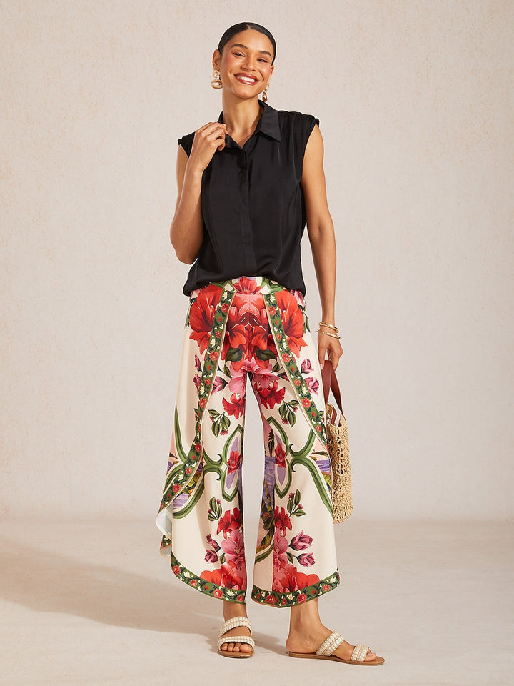 Wide leg pants featuring a high-rise waist in a silky satin fabric with a vibrant tropical floral print, perfect for stylish summer outings. 4