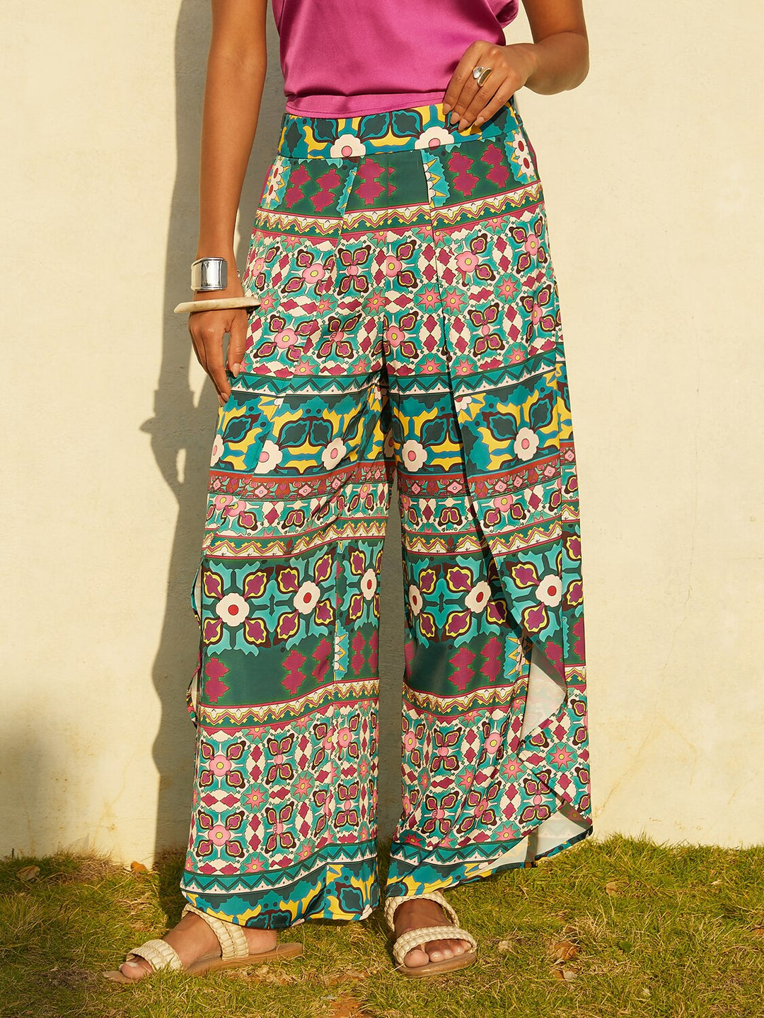Wide leg pants featuring a high-rise waist in a silky satin fabric with a vibrant tropical floral print, perfect for stylish summer outings. 9
