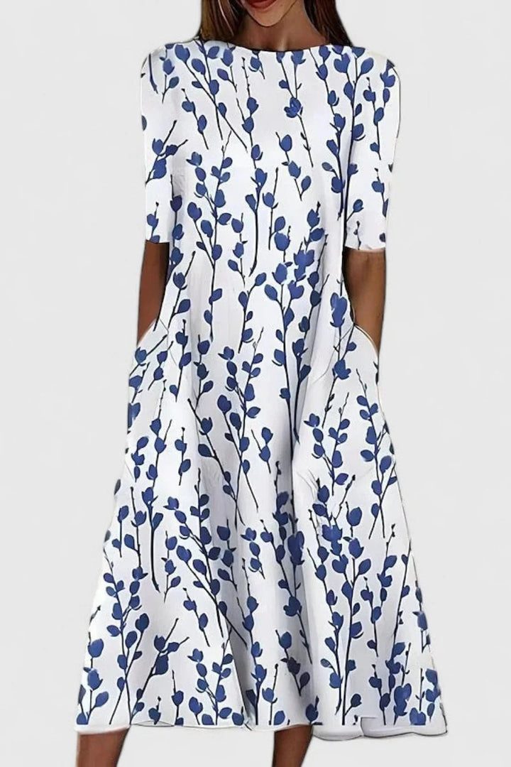 Women's A-Line Midi Dress with Pockets in breathable cotton featuring a blue floral pattern on a white background. 0
