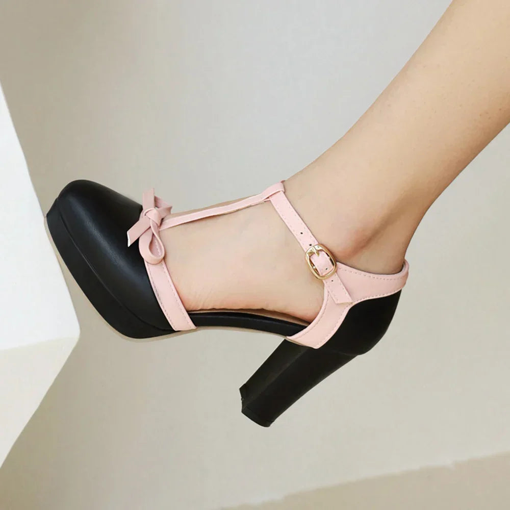 Women's black block heels featuring an adjustable buckle and faux patent leather T-strap design, ideal for stylish and comfortable wear. 3