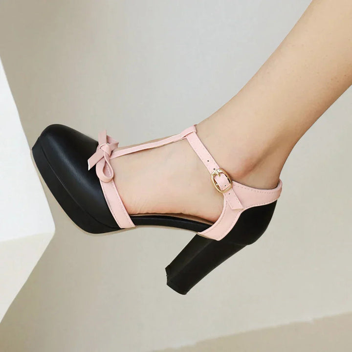 Women's black block heels featuring an adjustable buckle and faux patent leather T-strap design, ideal for stylish and comfortable wear. 3