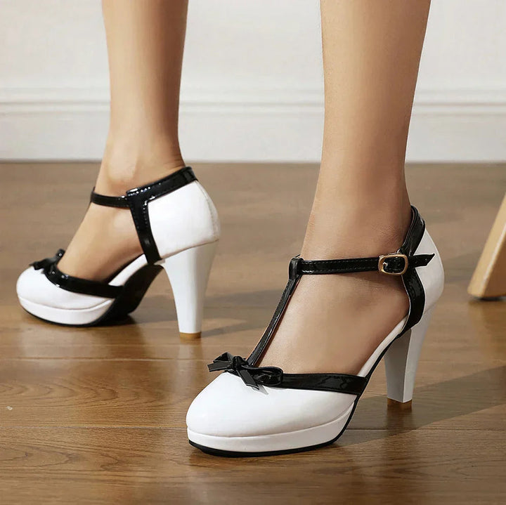 Women's black block heels featuring an adjustable buckle and faux patent leather T-strap design, ideal for stylish and comfortable wear. 4