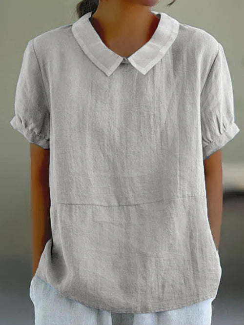 Women's white cotton blouse featuring puff sleeves and a Peter Pan collar, designed for a relaxed fit, perfect for summer wear. 4