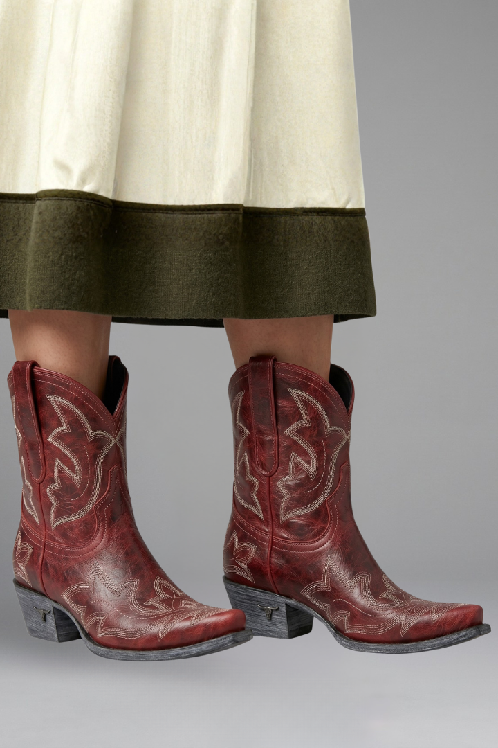 Women's cowboy boots featuring a leather upper, pointed toe, and western embroidered ankle design, complete with dual pull tabs for easy wear. 0