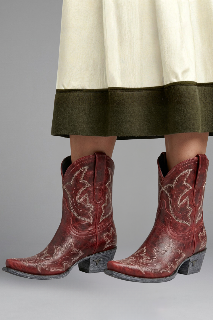 Women's cowboy boots featuring a leather upper, pointed toe, and western embroidered ankle design, complete with dual pull tabs for easy wear. 4