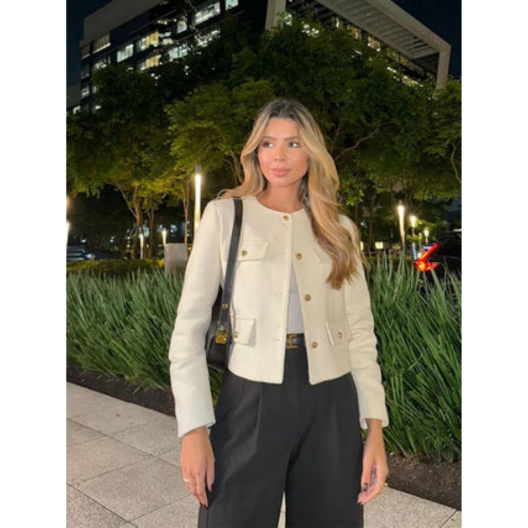 Women's cropped jacket featuring a tailored cream design, structured fit, and elegant gold button closure, perfect for stylish layering. 2