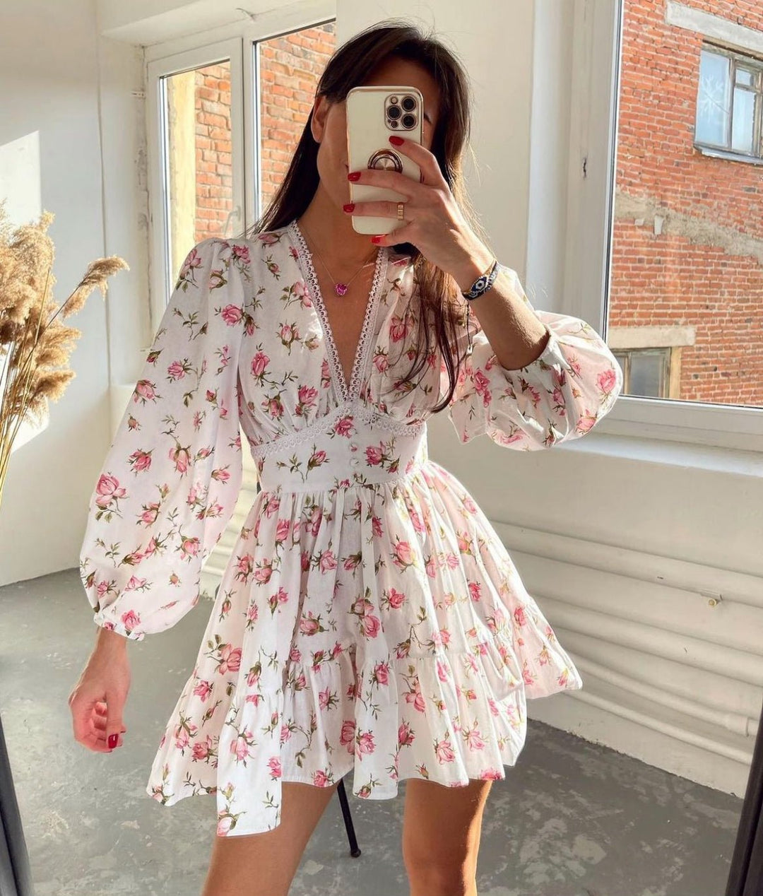 Women's floral mini dress featuring balloon sleeves and a crochet lace V-neck, perfect for summer outings and warm weather occasions. 0