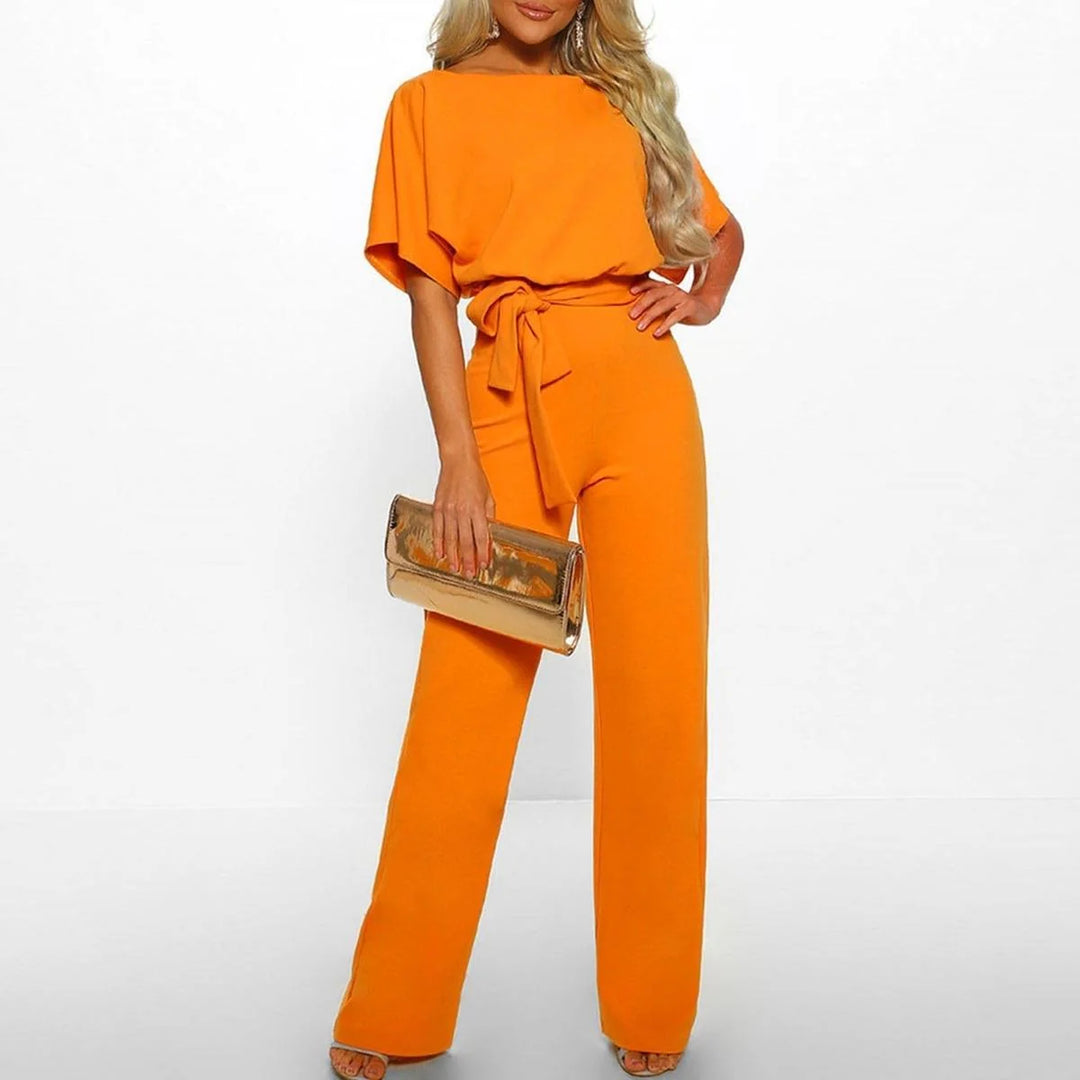 Women's jumpsuit featuring an adjustable belt and short sleeves, perfect for a casual, layer-friendly outfit. 1