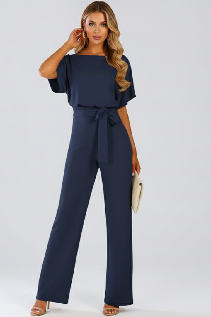 Women's black jumpsuit featuring short sleeves, a round neck, a stylish tie waist, and wide legs, perfect for casual or dressy occasions. 4