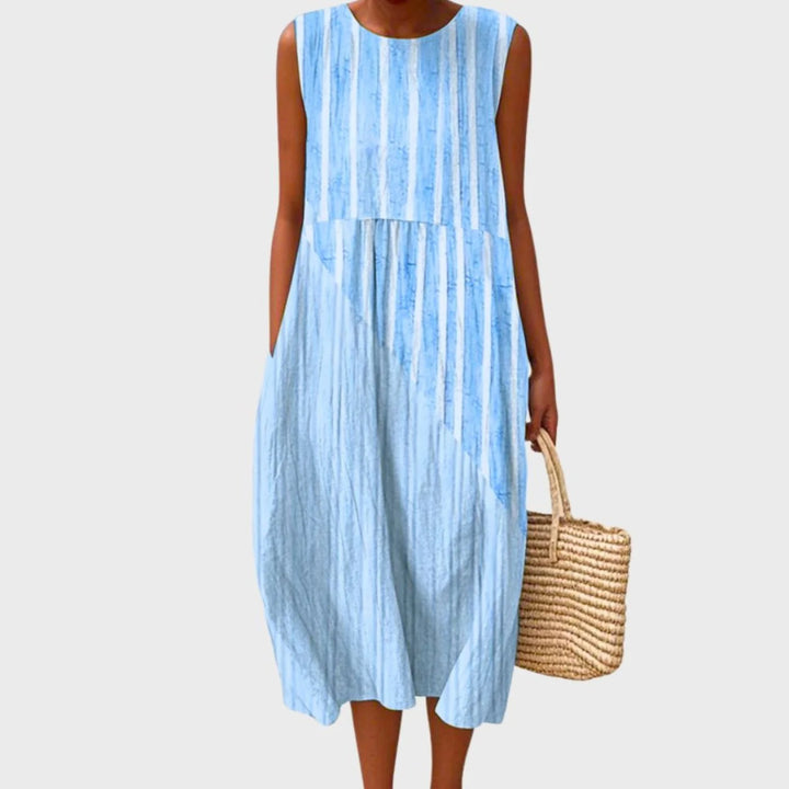 Women's linen midi dress featuring a relaxed fit and sleeveless design, showcasing a stylish blue and yellow check pattern. 1