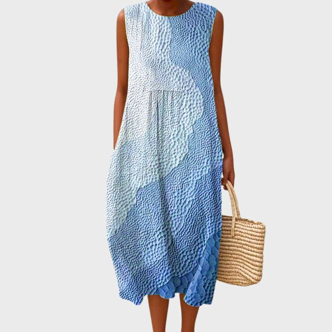 Women's linen midi dress featuring a relaxed fit and sleeveless design, showcasing a stylish blue and yellow check pattern. 2