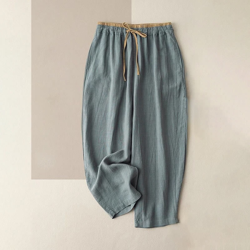 Women's linen pants featuring a comfortable drawstring and practical pockets, designed as casual long harem trousers for a relaxed and stylish look. 0