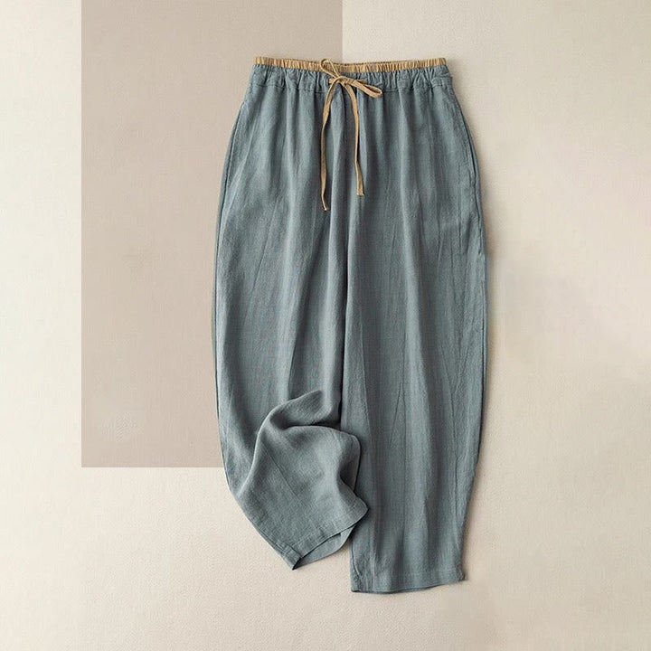 Women's linen pants featuring a comfortable drawstring and practical pockets, designed as casual long harem trousers for a relaxed and stylish look. 0