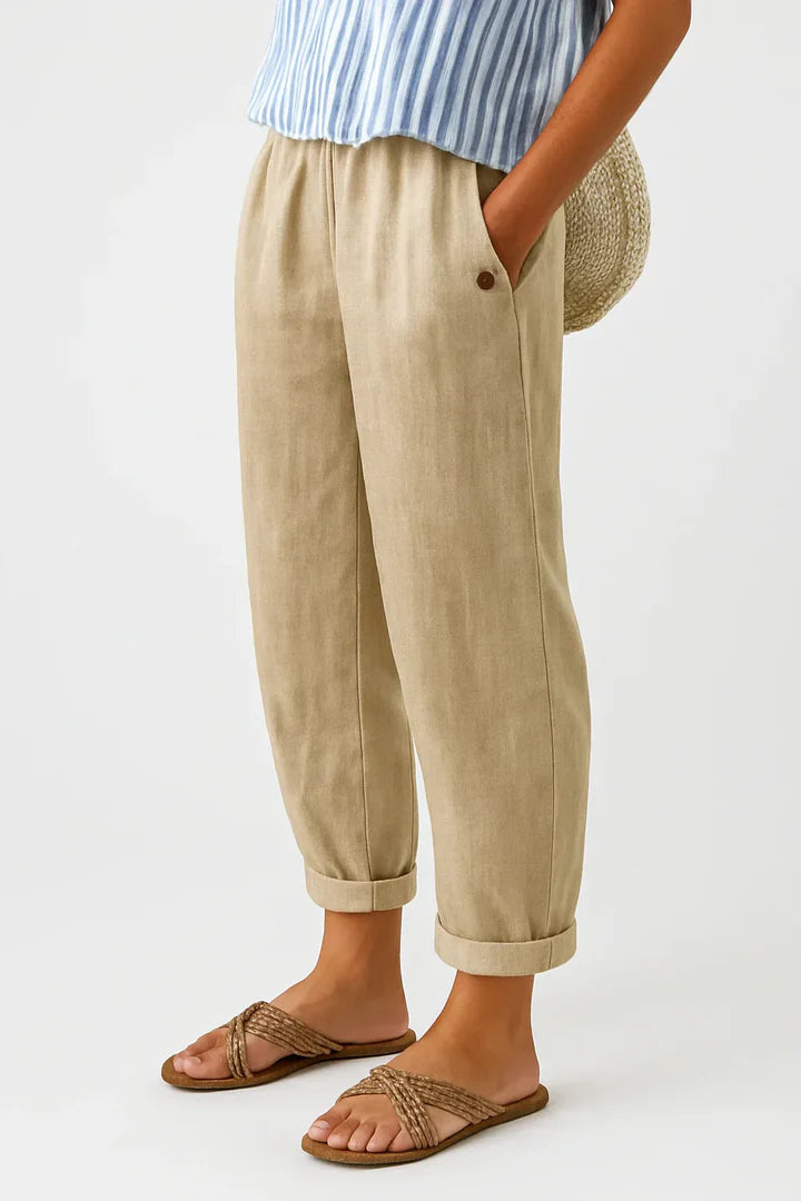 Women's breathable white linen pants featuring an elastic waistband and hidden pockets, perfect for summer wear. 0
