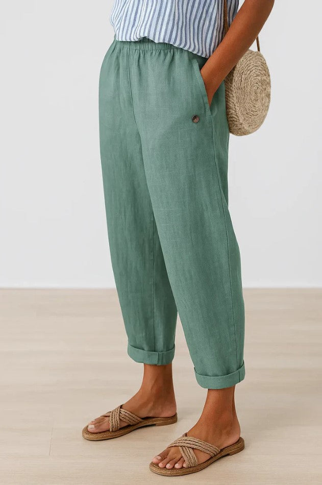 Women's breathable white linen pants featuring an elastic waistband and hidden pockets, perfect for summer wear. 5