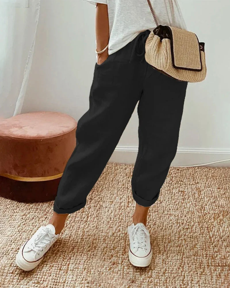 Women's breathable white linen pants featuring a relaxed fit, perfect for casual wear and warm weather styling. 1