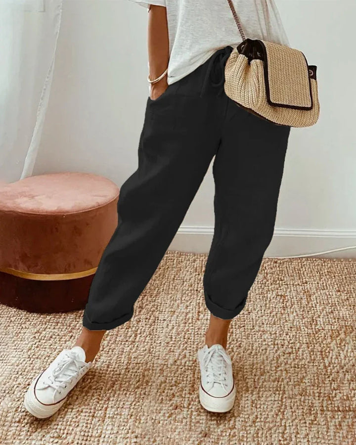 Women's breathable white linen pants featuring a relaxed fit, perfect for casual wear and warm weather styling. 1